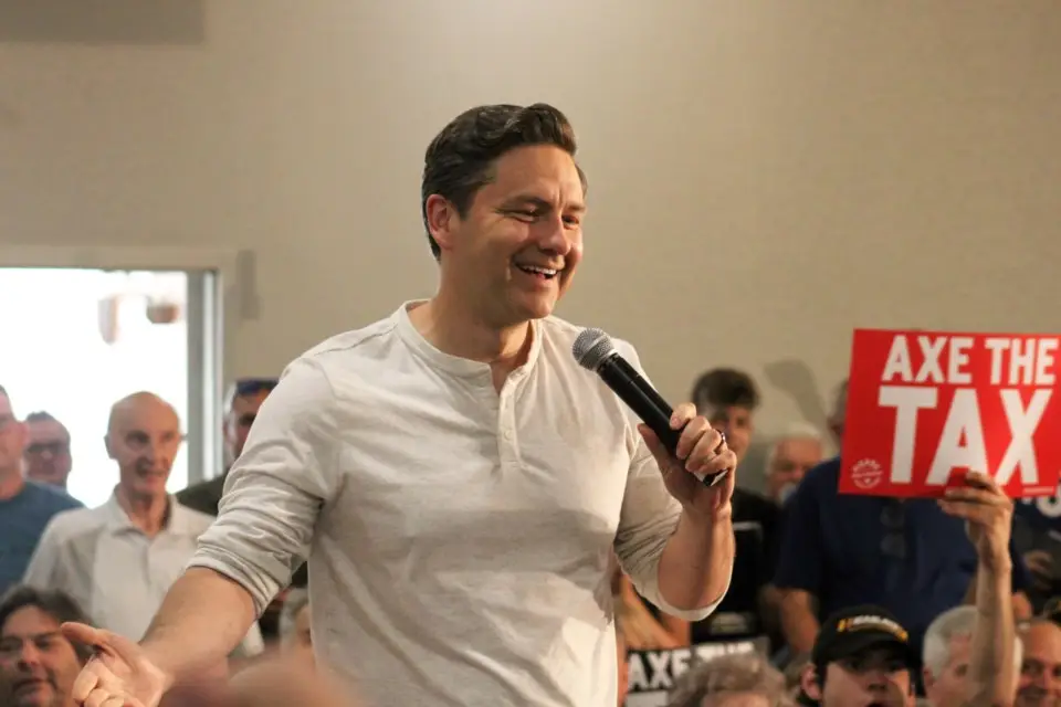 Pierre Pollievre holding a mic